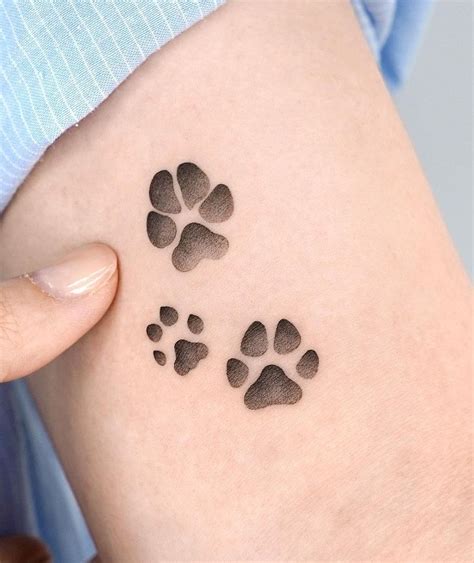 paw print tattoo|paw print tattoo on thigh.